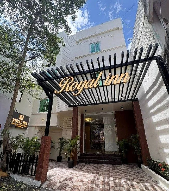 Hotel Royal Inn entrance with a black pergola and the Royal Inn sign
